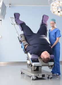 Bariatric male in Trendelenburg with TrenGuard and ArmGuard and nurse by his side